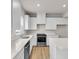 Bright kitchen featuring white cabinets, stainless steel appliances, quartz countertops, and an island at 5964 Lomita Ave, Plainfield, IN 46168