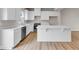 Modern kitchen with white cabinets, stainless steel appliances, and wood-look floors at 5964 Lomita Ave, Plainfield, IN 46168