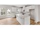 Bright kitchen featuring a large island, white cabinetry, and stainless steel appliances at 5964 Lomita Ave, Plainfield, IN 46168