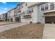 Townhome rear view highlighting garage parking, balcony spaces, and modern design at 5964 Lomita Ave, Plainfield, IN 46168