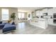 Open-concept kitchen with white cabinets, stainless steel appliances, and a breakfast bar, seamlessly flowing into the dining area at 6718 Thresher Pass, McCordsville, IN 46055
