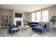 Bright and airy living room with large windows, a fireplace, and modern furnishings at 6718 Thresher Pass, McCordsville, IN 46055