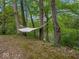 Serene backyard featuring a comfortable hammock slung between mature trees near the water's edge at 6827 S 500 W, Trafalgar, IN 46181