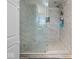 Beautiful bathroom featuring marble tile, glass shower door, and modern fixtures at 6827 S 500 W, Trafalgar, IN 46181