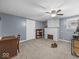 Bonus room offers cozy feel with a brick fireplace, neutral walls, and carpet flooring at 6827 S 500 W, Trafalgar, IN 46181