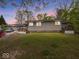 Exterior view of the home showcasing its neutral paint scheme and inviting front porch with manicured lawn at 6827 S 500 W, Trafalgar, IN 46181