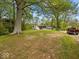 Expansive front yard featuring a charming home, recreational vehicle, and multiple parked cars on a sunny day at 6827 S 500 W, Trafalgar, IN 46181
