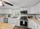 Bright kitchen featuring white cabinets, stainless steel appliances, and durable countertops at 6827 S 500 W, Trafalgar, IN 46181