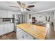 Spacious open-concept kitchen featuring white cabinets, stainless steel appliances, and a breakfast bar at 6827 S 500 W, Trafalgar, IN 46181