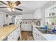 Updated kitchen featuring white cabinets, stainless steel appliances, and laminate wood flooring at 6827 S 500 W, Trafalgar, IN 46181