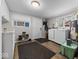 Bright laundry room offering storage space, modern washer and dryer, and wood flooring at 6827 S 500 W, Trafalgar, IN 46181