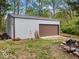 Durable outbuilding offers ample storage with its large door and an adjacent open area at 6827 S 500 W, Trafalgar, IN 46181