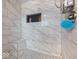 Bathroom showcases a shower with a built-in seat, tiled surround, and storage niche at 6827 S 500 W, Trafalgar, IN 46181