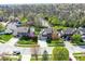 Aerial view of neighborhood houses with well-manicured lawns, mature trees, and pond at 701 Danver Ln, Beech Grove, IN 46107