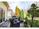 This backyard features a stone patio seating area with modern outdoor furniture and manicured trees at 701 Danver Ln, Beech Grove, IN 46107