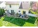 Aerial view of a backyard with a large patio, mature trees and a freshly stained fence at 701 Danver Ln, Beech Grove, IN 46107