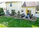 This backyard features a stone patio seating area and mature shade trees at 701 Danver Ln, Beech Grove, IN 46107