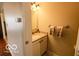 Cozy bathroom with a sink, vanity, mirror, and neutral wall color at 701 Danver Ln, Beech Grove, IN 46107