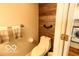 Modern bathroom featuring a toilet, textured walls, and towel rack at 701 Danver Ln, Beech Grove, IN 46107