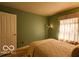 Bedroom featuring green walls and a window at 701 Danver Ln, Beech Grove, IN 46107