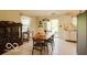 Cozy dining room with natural lighting, an adjacent kitchen, and tiled floors at 701 Danver Ln, Beech Grove, IN 46107