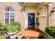 Close-up featuring a home's inviting entryway, adorned with potted plants and decorative hanging decor at 701 Danver Ln, Beech Grove, IN 46107