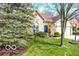 Charming home with an arched window, a manicured lawn, and a two-car garage, offering a welcoming appearance at 701 Danver Ln, Beech Grove, IN 46107