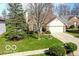 Attractive home with mature trees and a driveway leading to a two-car garage at 701 Danver Ln, Beech Grove, IN 46107