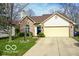 Attractive home with a manicured lawn and a driveway leading to a two-car garage at 701 Danver Ln, Beech Grove, IN 46107