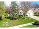 Charming home featuring a well-manicured lawn, mature trees, and inviting curb appeal at 701 Danver Ln, Beech Grove, IN 46107