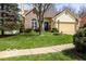 Charming brick home boasts a well-manicured lawn and a lovely garden, enhancing its curb appeal at 701 Danver Ln, Beech Grove, IN 46107