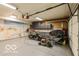 Organized garage featuring beach-themed mural wall, providing a unique and inviting workspace at 701 Danver Ln, Beech Grove, IN 46107