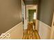 View of hallway with wooden flooring and bead board paneling at 701 Danver Ln, Beech Grove, IN 46107