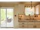 Cozy kitchen with granite counters and a view to outdoor seating at 701 Danver Ln, Beech Grove, IN 46107