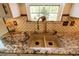 Granite countertops complement the patterned tile backsplash in this kitchen at 701 Danver Ln, Beech Grove, IN 46107