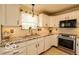 Modern kitchen featuring white cabinets and stainless steel appliances at 701 Danver Ln, Beech Grove, IN 46107