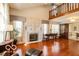 Spacious living room with hardwood floors, a fireplace, and ample natural light, perfect for gatherings at 701 Danver Ln, Beech Grove, IN 46107