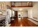 Bright living room with hardwood floors, a fireplace, and large windows, perfect for relaxing and entertaining at 701 Danver Ln, Beech Grove, IN 46107
