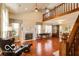 Bright living room with high ceilings, a fireplace, and large windows, creating a welcoming atmosphere at 701 Danver Ln, Beech Grove, IN 46107