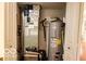 Functional utility room with water heater, furnace, and ample storage space at 701 Danver Ln, Beech Grove, IN 46107