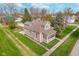 Aerial view of a charming home with a well-maintained yard and mature trees at 702 S Fanning St, Sheridan, IN 46069