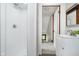 Bathroom featuring a tiled shower, modern fixtures, and a vanity, with an open hallway at 702 S Fanning St, Sheridan, IN 46069