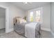 Cozy bedroom with a plush bed, soft carpeting, and a window offering natural light at 702 S Fanning St, Sheridan, IN 46069