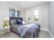 Charming bedroom featuring a comfortable bed, plush carpeting, and a bright window view at 702 S Fanning St, Sheridan, IN 46069