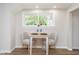 Cozy dining area features an intimate dining table set for two with a view of the outdoors through the window at 702 S Fanning St, Sheridan, IN 46069