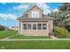 Inviting home with a manicured lawn, mature tree, and cozy front porch at 702 S Fanning St, Sheridan, IN 46069
