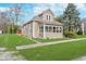 Charming tan house with a well-maintained lawn and front porch at 702 S Fanning St, Sheridan, IN 46069