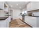 Bright kitchen with white cabinets, wood countertops, stainless steel dishwasher and modern fixtures at 702 S Fanning St, Sheridan, IN 46069