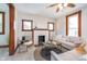 Cozy living room with fireplace, wood trim, and comfortable seating at 702 S Fanning St, Sheridan, IN 46069