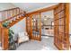 Inviting interior view showcasing wood trim staircase, glass-paneled doors and a view into the spacious living room at 702 S Fanning St, Sheridan, IN 46069